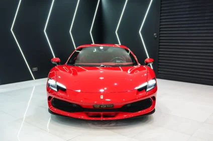 Front view of a Ferrari showcasing its bold grille and LED headlights, available for leasing in Dubai