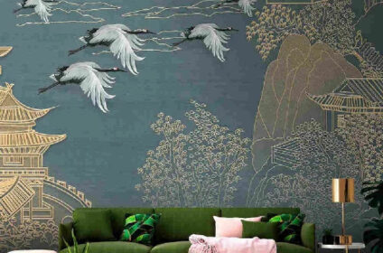 A green sofa with pink and green pillows is in front of a blue and gold mural wallpaper (1)